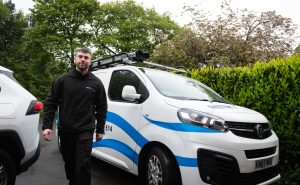 A Metro Plumb engineer walking away from his van