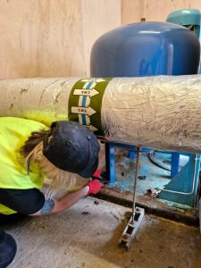 A Metro Plumb engineer assessing a booster pump