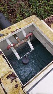 Water storage tank for a booster pump