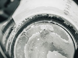 A picture of a kettle with limescale build up on the inside